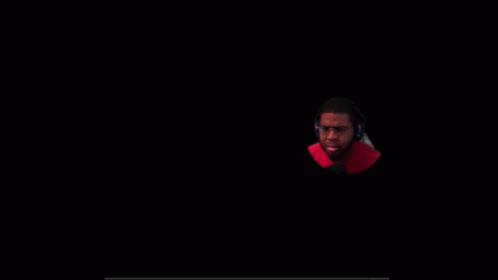 A Man Wearing Glasses And Headphones Is Looking At The Camera GIF