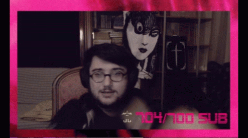 A Man Wearing Glasses And Headphones Is Sitting In Front Of A Pink Background That Says 104/100 Sub GIF