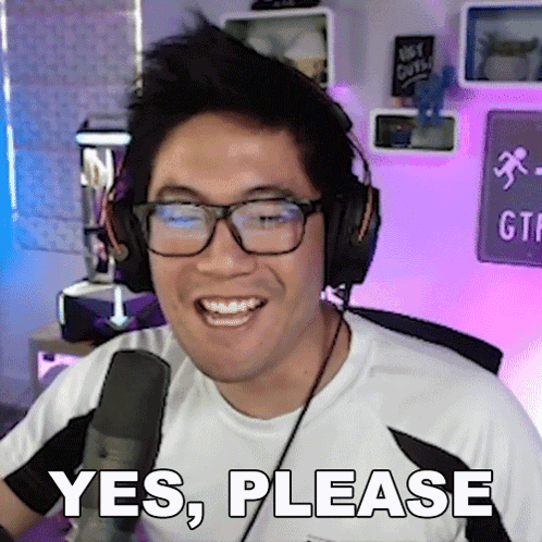 A Man Wearing Glasses And Headphones Is Smiling And Says Yes Please GIF