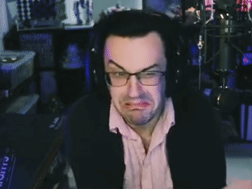 A Man Wearing Glasses And Headphones Making A Face GIF