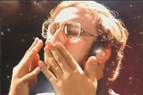 A Man Wearing Glasses Covers His Mouth With His Hands GIF