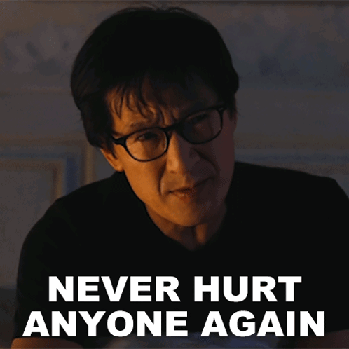 A Man Wearing Glasses Has The Words Never Hurt Anyone Again Above His Head GIF