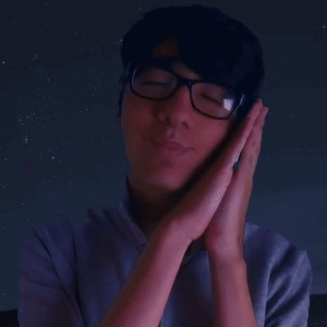 A Man Wearing Glasses Holds His Hands To His Face In Prayer GIF