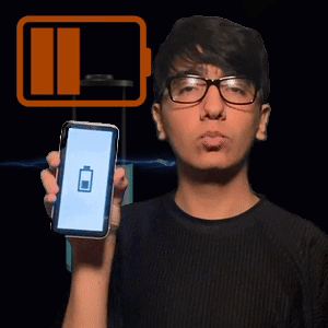 A Man Wearing Glasses Holds Up A Cell Phone With A Battery Icon On The Screen GIF