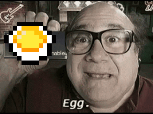 A Man Wearing Glasses Holds Up A Pixelated Egg With The Word Egg Below It GIF