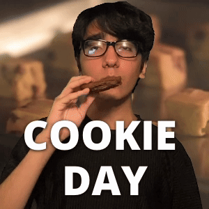 A Man Wearing Glasses Is Eating A Cookie With The Words Cookie Day Behind Him GIF