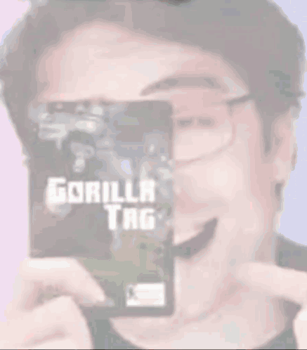 A Man Wearing Glasses Is Holding A Gorilla Tag Card GIF