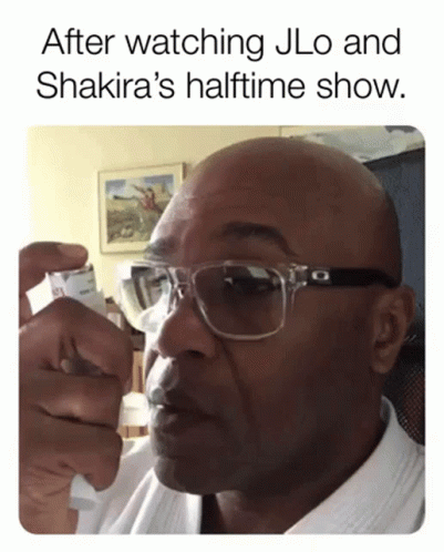 A Man Wearing Glasses Is Holding A Lighter In His Hand With The Caption After Watching Jlo And Shakira 'S Halftime GIF