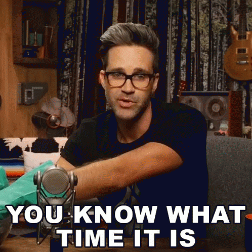 A Man Wearing Glasses Is Holding A Microphone And Says " You Know What Time It Is " GIF
