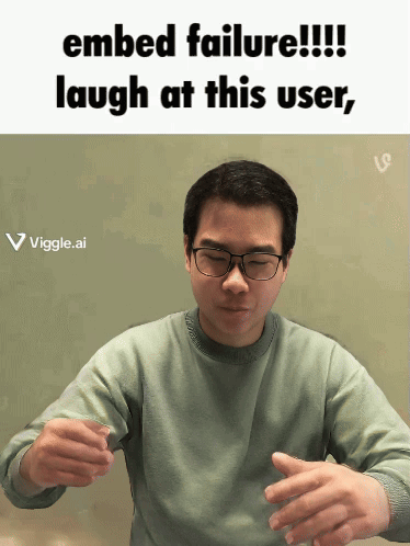 A Man Wearing Glasses Is Laughing At A Failed Embed GIF