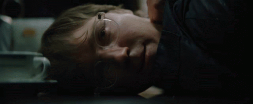 A Man Wearing Glasses Is Laying Down With His Eyes Closed GIF
