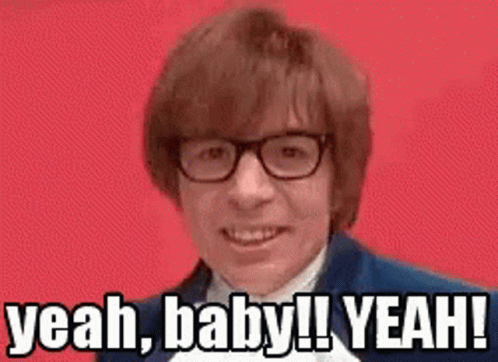 A Man Wearing Glasses Is Making A Funny Face And Saying Yeah , Baby ! Yeah ! GIF