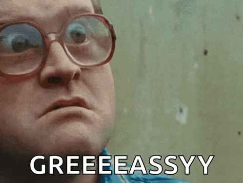 A Man Wearing Glasses Is Making A Funny Face And Says Greeeeassyy GIF
