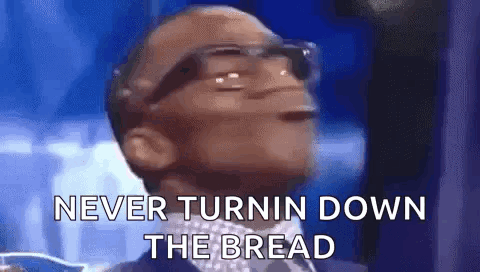 A Man Wearing Glasses Is Saying `` Never Turnin Down The Bread '' While Wearing A Suit And Tie . GIF