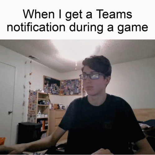 A Man Wearing Glasses Is Sitting At A Desk With A Caption That Says When I Get A Teams Notification GIF