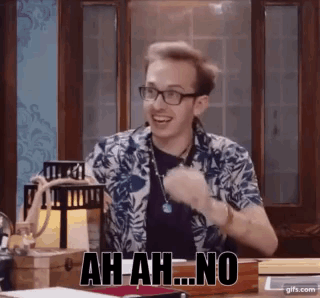 A Man Wearing Glasses Is Sitting At A Table And Making A Funny Face And Saying Ah-Ah-No . GIF