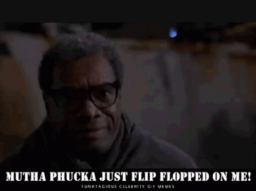 A Man Wearing Glasses Is Sitting In A Dark Room And Says `` Mutha Phucka Just Flip Flopped On Me '' . GIF