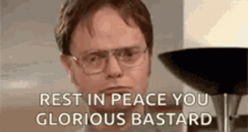 A Man Wearing Glasses Is Sitting In Front Of A Lamp And Says `` Rest In Peace You Glorious Bastard '' . GIF