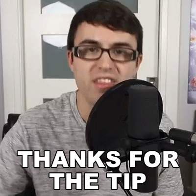 A Man Wearing Glasses Is Sitting In Front Of A Microphone And Saying Thanks For The Tip . GIF