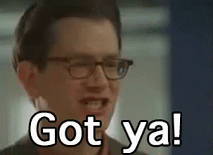 A Man Wearing Glasses Is Smiling And Saying `` Got Ya ! '' GIF