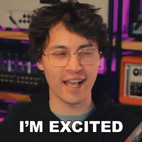A Man Wearing Glasses Is Smiling And Saying I 'M Excited . GIF