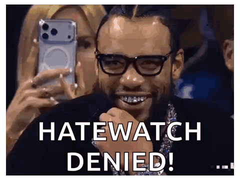 A Man Wearing Glasses Is Smiling While A Woman Takes A Picture Of Him With A Cell Phone . GIF
