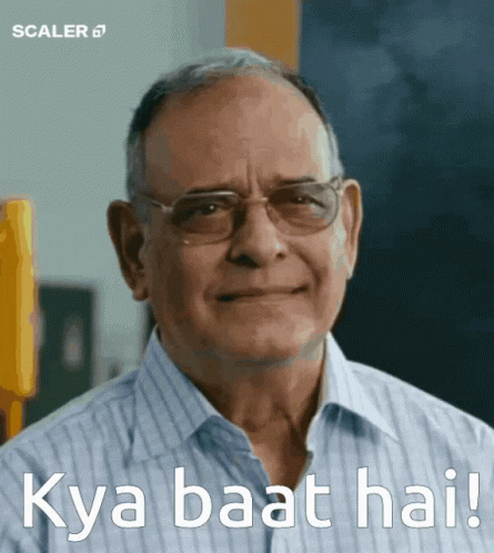 A Man Wearing Glasses Is Smiling With The Words Kya Baat Hai Written Below Him GIF