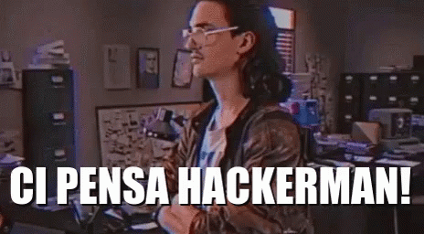 A Man Wearing Glasses Is Standing In An Office With The Words `` Ci Pensa Hackermani '' Written On The Bottom . GIF