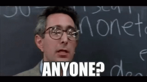 A Man Wearing Glasses Is Standing In Front Of A Blackboard And Saying `` Anyone ? '' . GIF