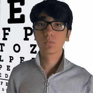 A Man Wearing Glasses Is Standing In Front Of An Eye Chart With The Letter E On It GIF