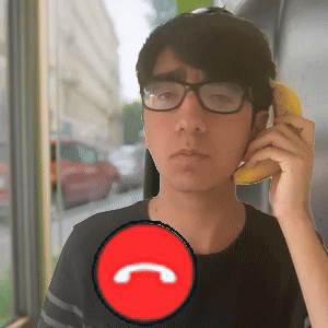 A Man Wearing Glasses Is Talking On A Phone With A Red Circle With The Letter C In It GIF