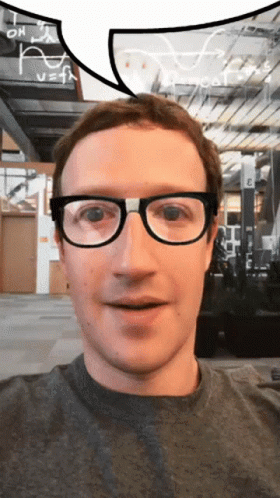 A Man Wearing Glasses Looks At The Camera With A Speech Bubble Above His Head GIF
