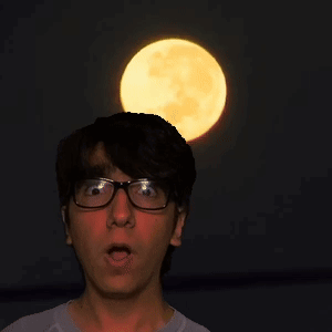 A Man Wearing Glasses Looks Up At The Full Moon GIF