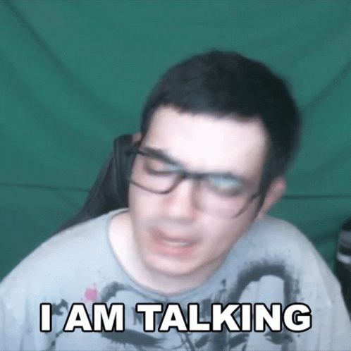 A Man Wearing Glasses Says " I Am Talking " GIF