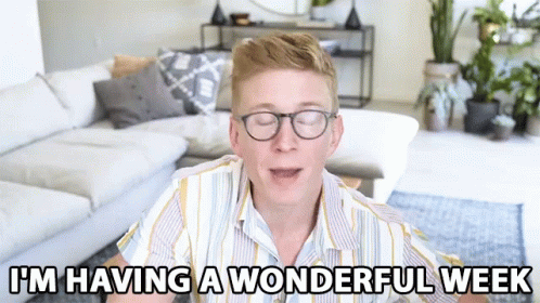 A Man Wearing Glasses Says I 'M Having A Wonderful Week In A Living Room GIF