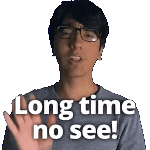 a man wearing glasses says long time no see with his hand