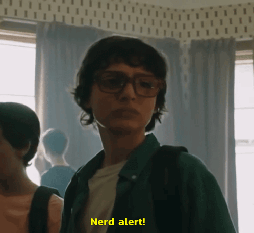 A Man Wearing Glasses Says Nerd Alert GIF
