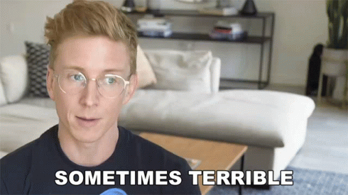 A Man Wearing Glasses Says " Sometimes Terrible " In Front Of A Couch GIF