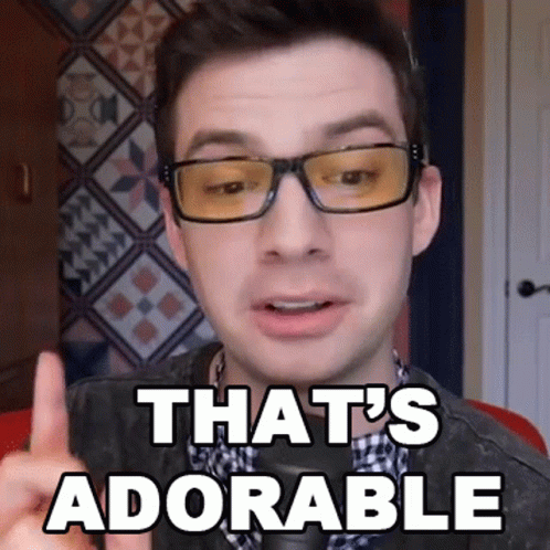 A Man Wearing Glasses Says That 'S Adorable With His Finger GIF