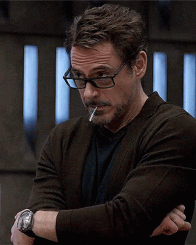 A Man Wearing Glasses Smoking A Cigarette And A Watch GIF
