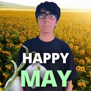 A Man Wearing Glasses Stands In Front Of A Field Of Sunflowers With The Words " Happy May " On The Bottom GIF