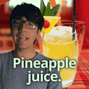 A Man Wearing Glasses Stands In Front Of A Pineapple Juice GIF