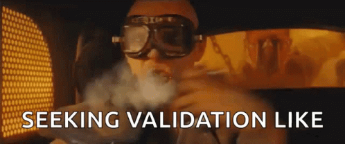 A Man Wearing Goggles Is Smoking A Cigarette And The Words `` Seeking Validation Like '' Are Visible In The Background . GIF