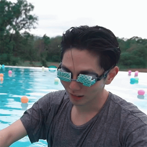 A Man Wearing Goggles Is Standing In A Pool Of Water GIF