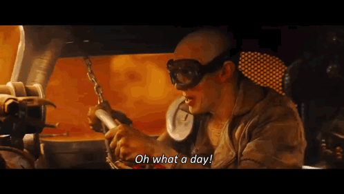A Man Wearing Goggles Says " Oh What A Day " While Holding A Chain GIF