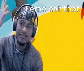 A Man Wearing Headphones And A Bandana Is Making A Funny Face . GIF
