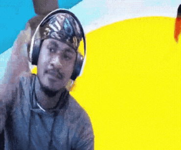 A Man Wearing Headphones And A Bandana On His Head Stands In Front Of A Yellow And Blue Background GIF