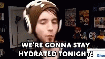 a man wearing headphones and a beanie is saying `` we 're gonna stay hydrated tonight ! ''