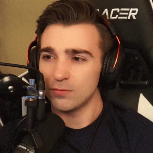 A Man Wearing Headphones And A Black Acer Chair GIF