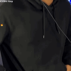 A Man Wearing Headphones And A Black Hoodie Is Standing In Front Of A Computer Screen . GIF